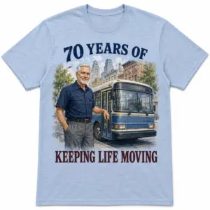 Front view of 70 years bus driver T-shirt with blue city bus and keeping life moving text