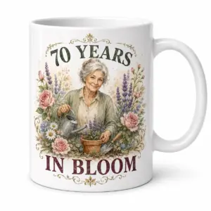 White ceramic mug closeup with 70 YEARS IN BLOOM gardening artwork and floral botanical details