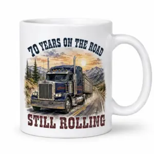 White ceramic mug with blue semi-truck mountain road artwork and the text 70 Years on the Road and Still Rolling